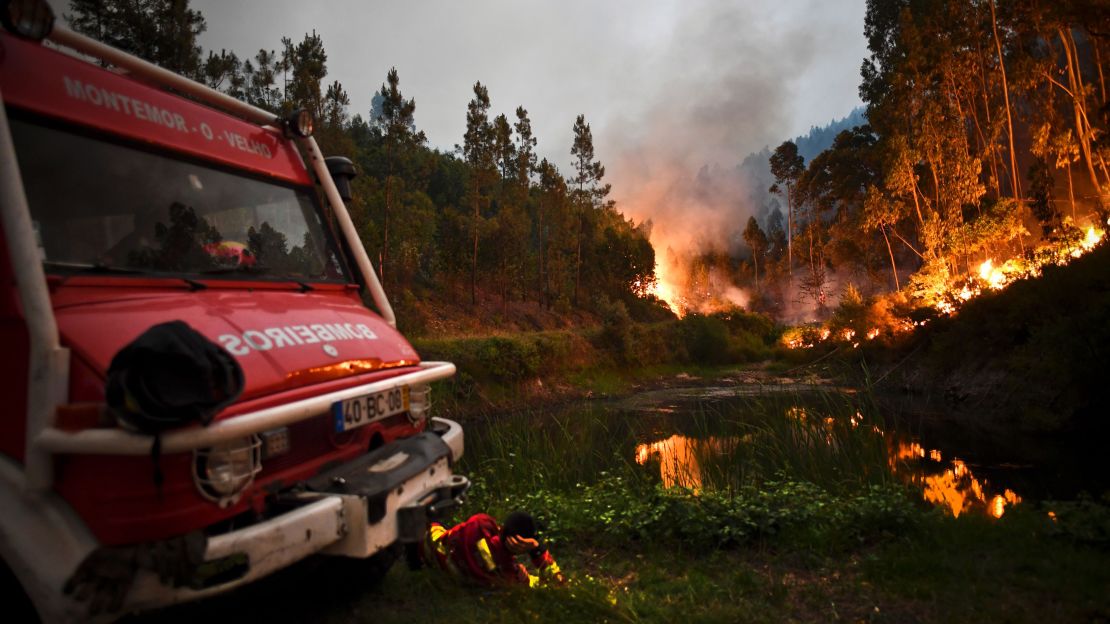 A firefighter rests next to a fire combat truck in Penela, Coimbra, on June 18. 