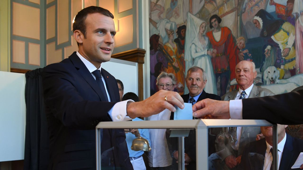 French President Emmanuel Macron casts his ballot as he votes at a polling station in Le Touquet, northern France, during the second round of the French parliamentary elections (elections legislatives in French), on June 18, 2017.  / AFP PHOTO / POOL AND AFP PHOTO / CHRISTOPHE ARCHAMBAULT        (Photo credit should read CHRISTOPHE ARCHAMBAULT/AFP/Getty Images)