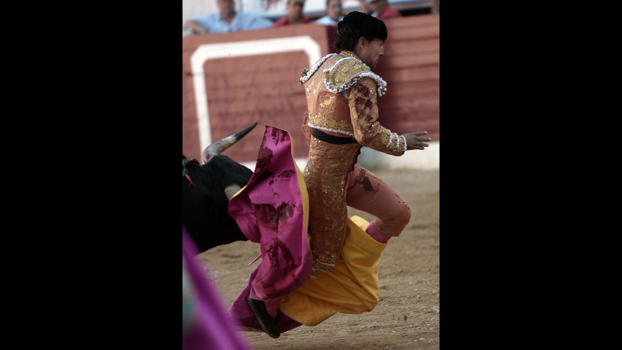 Fandiño gets tripped up in his cape on Saturday. The bull gored him after he fell. 