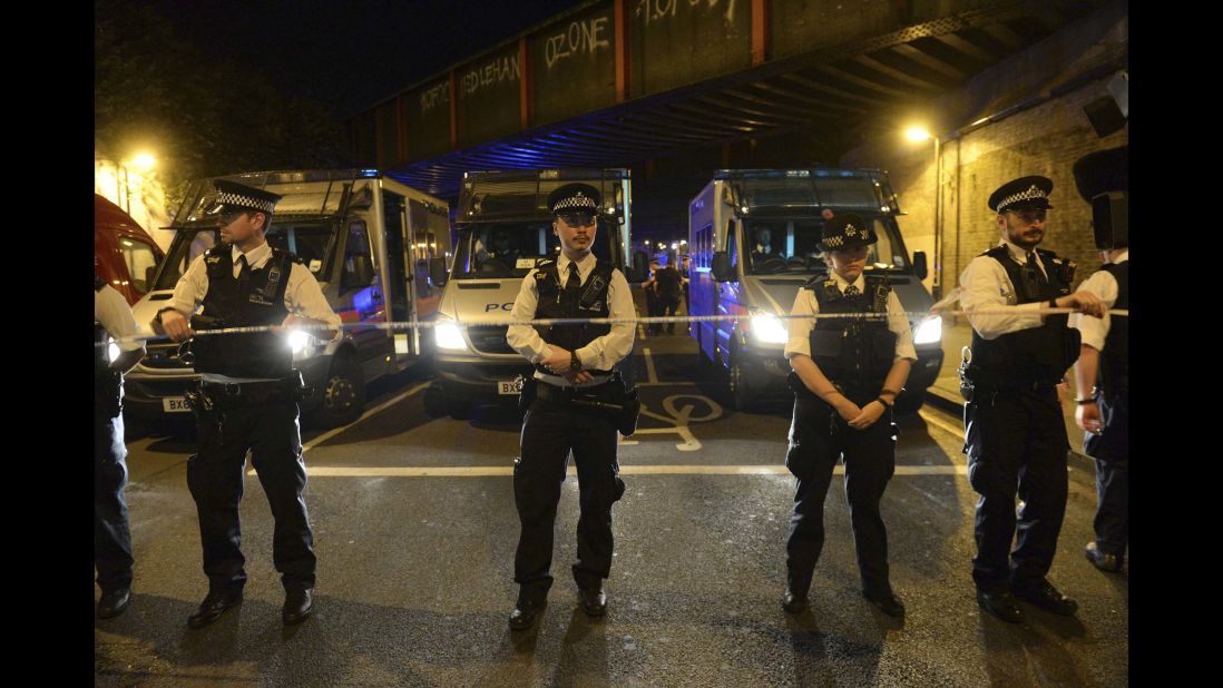 Police officers stand guard.