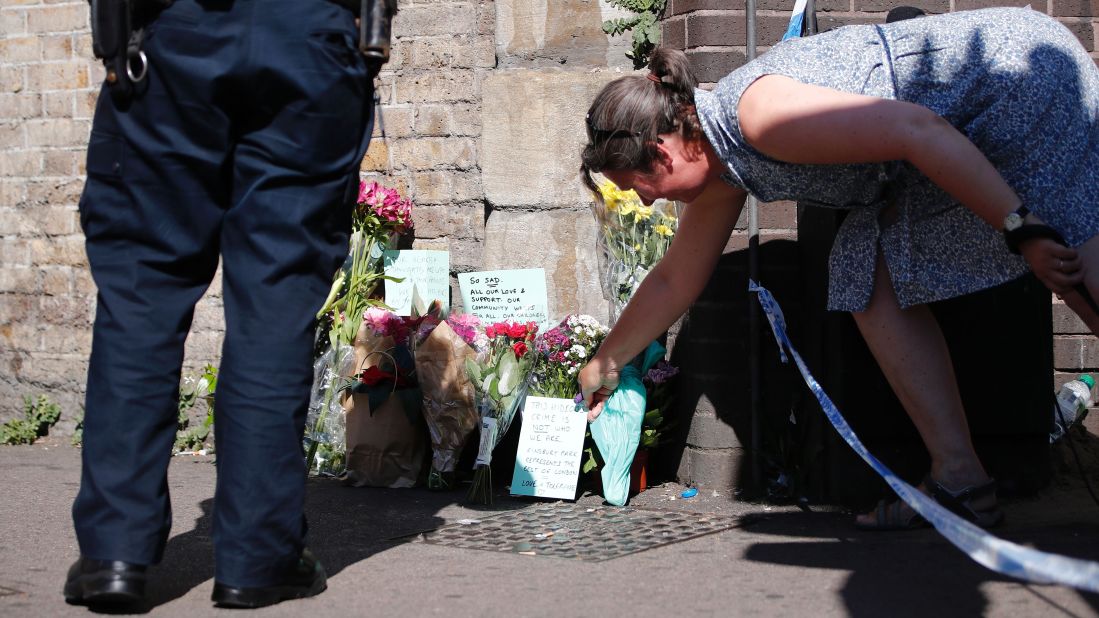 A woman lays flowers near the scene where a van <a href="http://www.cnn.com/2017/06/18/europe/urgent---london-vehicle-collision/index.html" target="_blank">plowed into a crowd of pedestrians in north London</a> on Monday, June 19. A man was arrested, police said, and is being held on suspicion of terrorism offenses. The attack happened near a mosque, and British Prime Minister Theresa May said it was directed at Muslims.