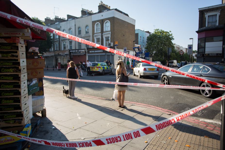 Pedestrians watch investigators at work.