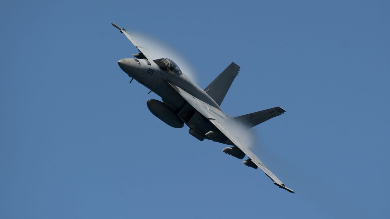 110603-N-DR144-167
PACIFIC OCEAN (June 3, 2011) An F/A-18E Super Hornet assigned to Strike Fighter Squadron (VFA) 81 maneuvers over the Nimitz-class aircraft carrier USS Carl Vinson (CVN 70) during an air power demonstration. Carl Vinson and Carrier Air Wing (CVW) 17 are underway in the U.S. 7th Fleet area of responsibility. (U.S. Navy photo by Mass Communication Specialist 2nd Class James R. Evans/Released)