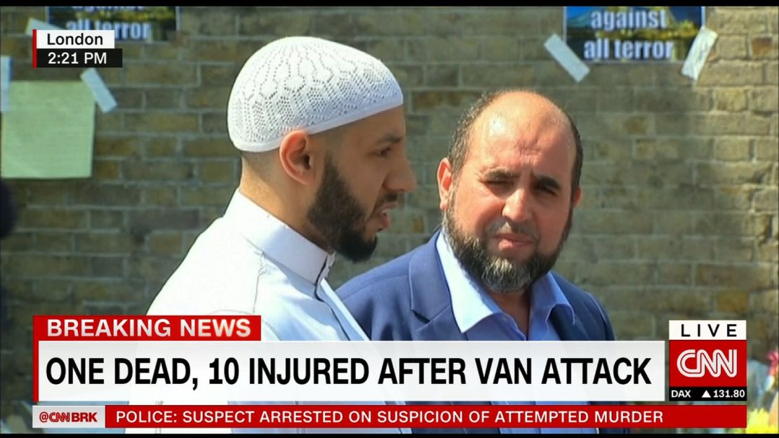 Imam Mohammed Mahmoud (in white hat and tunic) told the media what had happened outside his mosque was "a tragic and barbaric terrorist attack."