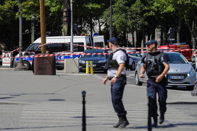 Police officers walk near a sealed-off area on the Champs-Elysees. The incident took place at 3:40 p.m. local time (9:40 a.m. ET).
