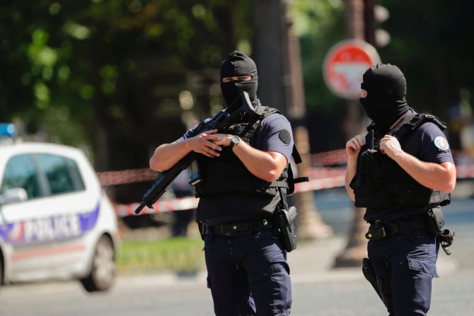 Police officers patrol the Champs-Elysees.