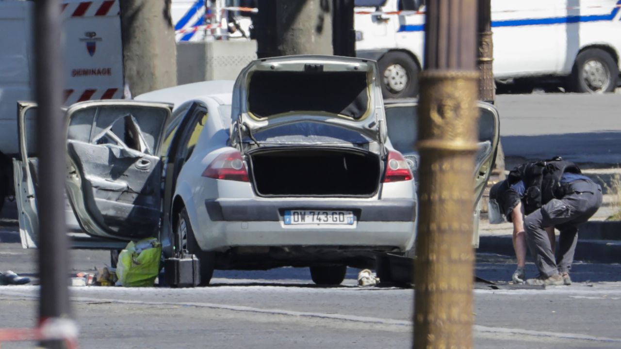 A bomb disposal police officer checks a car in a sealed off area on the Champs-Elysees avenue in Paris on Monday.
