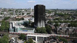 LONDON, ENGLAND - JUNE 16:  A tube train passes the remains of Grenfell Tower, seen from a neighbouring tower block on June 16, 2017 in London, England. 30 people have been confirmed dead and dozens still missing after the 24 storey residential Grenfell Tower block in Latimer Road was engulfed in flames in the early hours of June 14. Emergency services will spend a third day searching through the building for bodies. Police have said that some victims may never be identified.  (Photo by Carl Court/Getty Images)