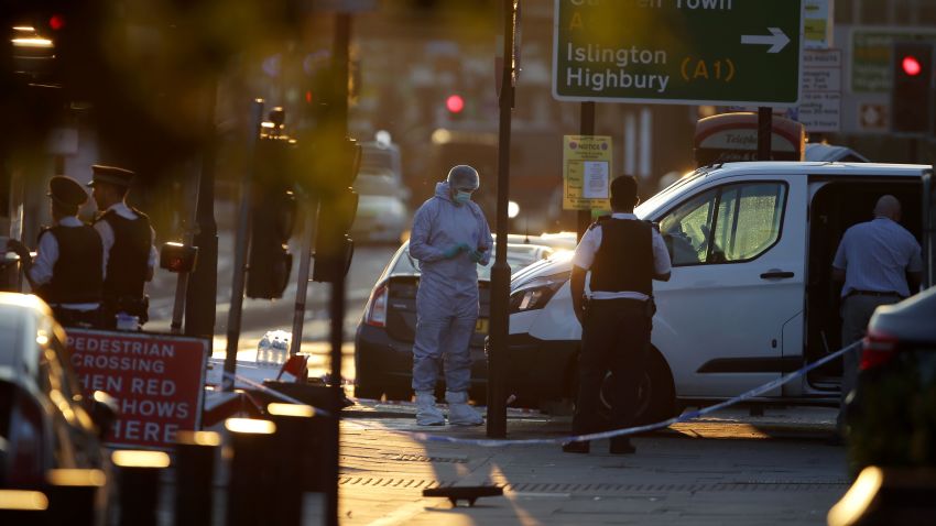Forensic investigators work the scene in the Finsbury Park area of north London after a vehicle hit pedestrians on June 19, 2017. 
One man was killed and eight people hospitalized when a van ran into pedestrians near a mosque in north London in an incident that is being investigated by counter-terrorism officers, police said on Monday. The 48 year old male driver of the van "was found detained by members of the public at the scene and then arrested by police," a police statement said.