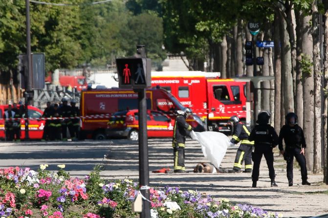 Rescue workers cover the suspect's body on the Champs-Elysees.