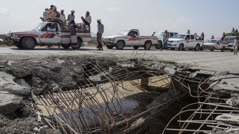 Cars and trucks wait in line to pass over a bridge that was hit by an airstrike in 2016 -- one of just four roads linking Al Hudaydah with the rest of the country. 