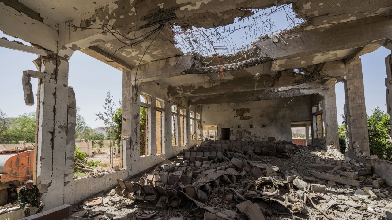 A military guard sits in the former Assembly Hall of the Governor of Saada that now lies in ruins following multiple airstrikes in April 2015. 