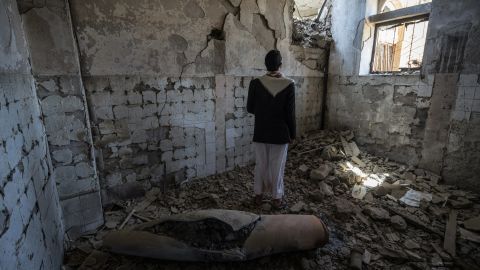 A man stands next to a missile casing in a former government building in Saada City, which was attacked in April 2015. Since the conflict escalated, two years ago, much of the city's infrastructure has been destroyed. 