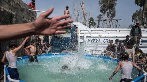 Children play in a pool of water in the Harat Al-Masna'a slum in Sana'a. The slum, which is close to an urban military base, was hit by two airstrikes last year on the Eid Al-Adha holiday, destroying 25 houses. 