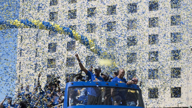 Kevin Durant waves to the crowd in Oakland, California, during the Golden State Warriors' victory parade on Thursday, June 15. Durant was the NBA Finals' most valuable player as <a href="index.php?page=&url=http%3A%2F%2Fwww.cnn.com%2F2017%2F06%2F02%2Fsport%2Fgallery%2Fnba-finals%2Findex.html" target="_blank">the Warriors defeated Cleveland</a> to win their second title in three seasons.