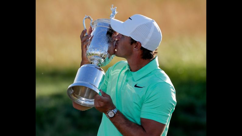 Brooks Koepka kisses his trophy after <a href="index.php?page=&url=http%3A%2F%2Fwww.cnn.com%2F2017%2F06%2F18%2Fsport%2Fus-open-2017-final-round%2Findex.html" target="_blank">winning the US Open</a> on Sunday, June 18. Koepka won by four shots to collect the first major title of his career.