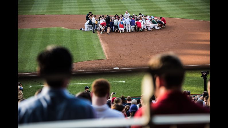 A prayer is held on the field before the start of the Congressional Baseball Game on Thursday, June 15. Democrats and Republicans <a href="index.php?page=&url=http%3A%2F%2Fwww.cnn.com%2Finteractive%2F2017%2F06%2Fpolitics%2Fcongressional-baseball-game-cnnphotos%2Findex.html" target="_blank">played the annual charity game</a> just a day after a gunman opened fire at a GOP practice, injuring US Rep. Steve Scalise and several others.