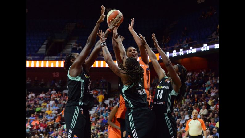 Connecticut's Alyssa Thomas is defended by three New York players during a WNBA game in Uncasville, Connecticut, on Wednesday, June 14. Thomas scored 18 points as Connecticut won the game 96-76.