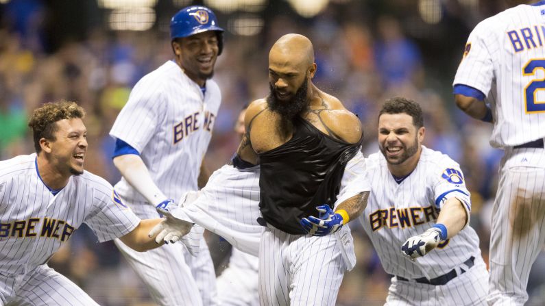 Eric Thames has his jersey ripped off by his Milwaukee teammates after his walk-off home run against San Diego on Friday, June 16.
