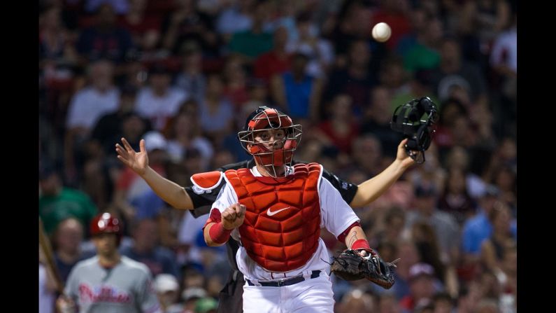 An umpire stands behind Boston catcher Christian Vazquez during a game on Tuesday, June 13.