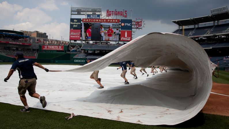 The Nationals Park grounds crew removes a tarp before a game in Washington on Wednesday, June 14. <a href="index.php?page=&url=http%3A%2F%2Fwww.cnn.com%2F2017%2F06%2F13%2Fsport%2Fgallery%2Fwhat-a-shot-sports-0612%2Findex.html" target="_blank">See 25 amazing sports photos from last week</a>