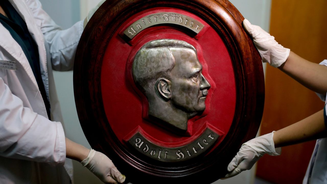Police show a bust relief portrait of Adolf Hitler at the Interpol headquarters in Buenos Aires on June 16.