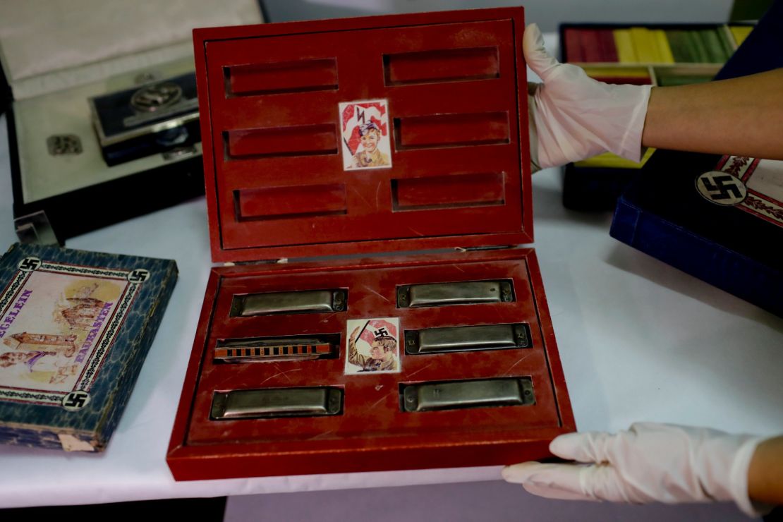 A member of the federal police shows a box containing harmonicas.