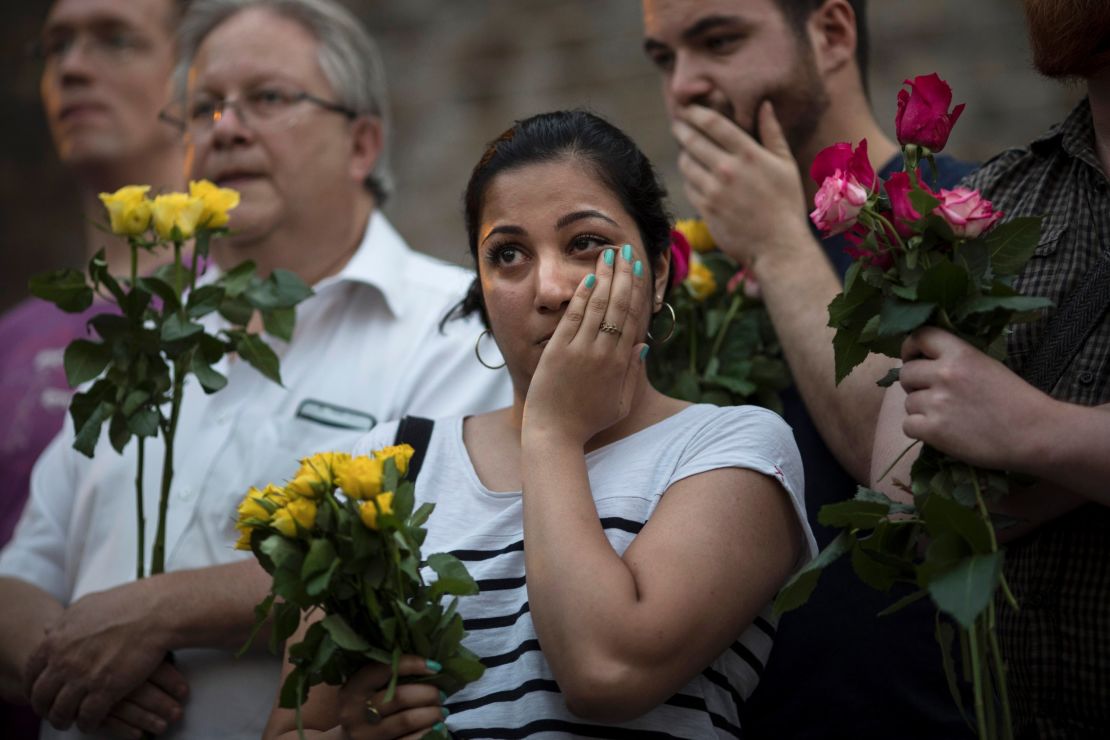 A woman reacts as she attends the vigil near Finsbury Park Mosque. 