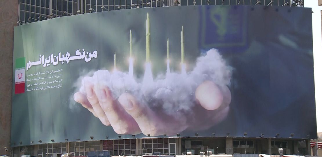 A billboard in Tehran depicting the firing of missiles from the metaphorical palm of the Revolutionary Guards. It reads "I am the guardian of Iran."