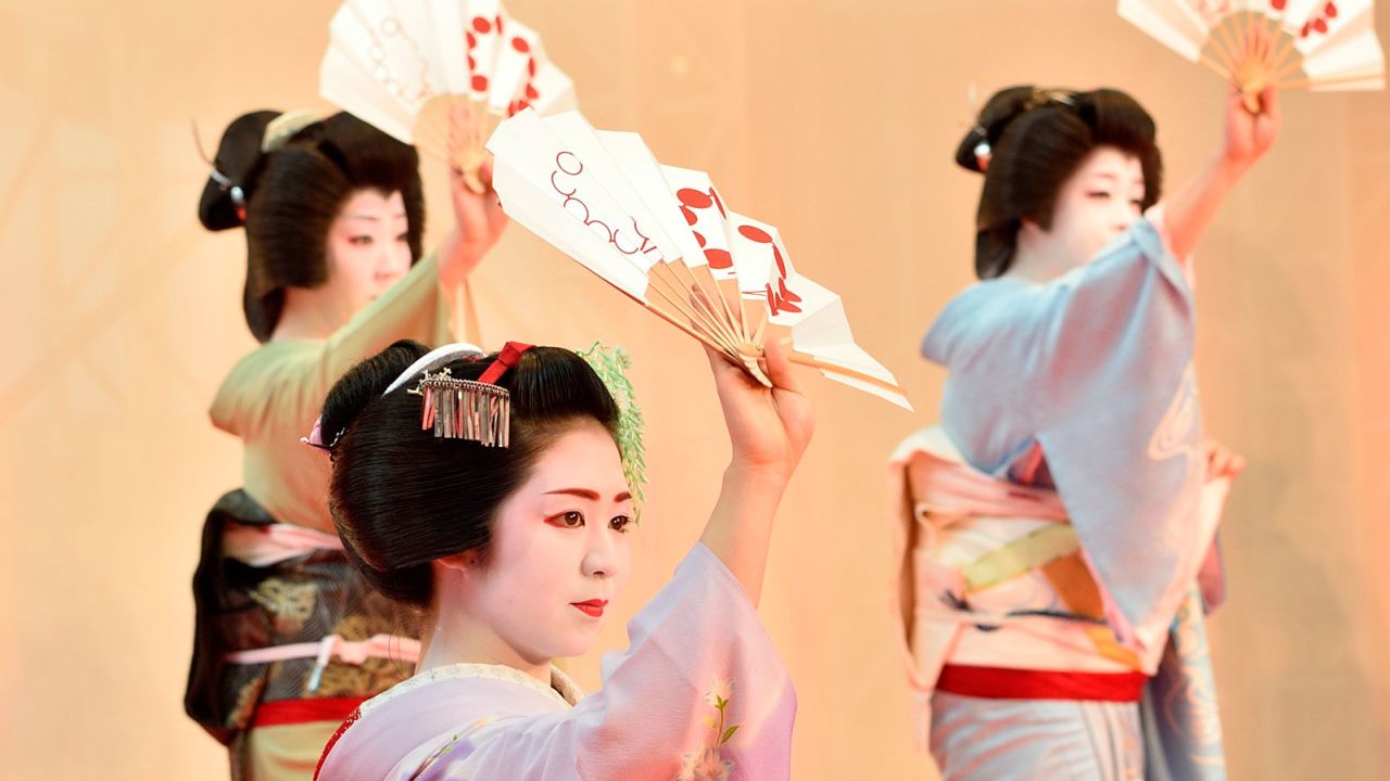 Maiko performing a traditional dance during a special event in Kyoto.