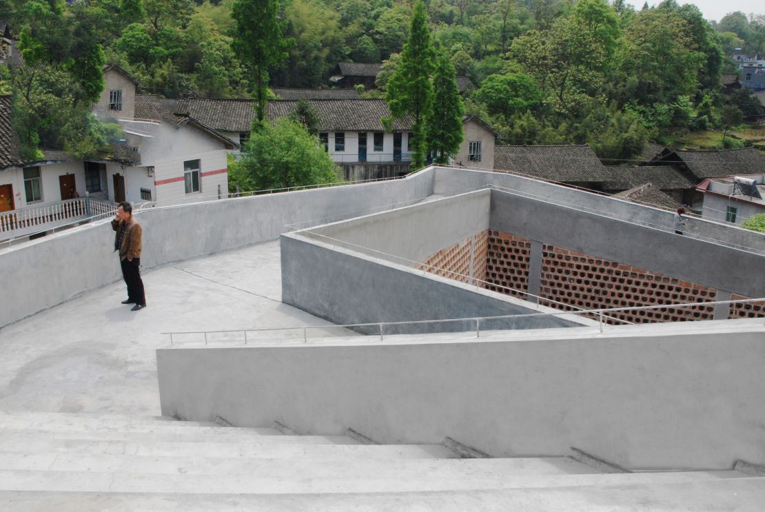 Angdong Hospital's  angular, futuristic roof terrace contrasts with the traditional tiled roofs in the surrounding village. 