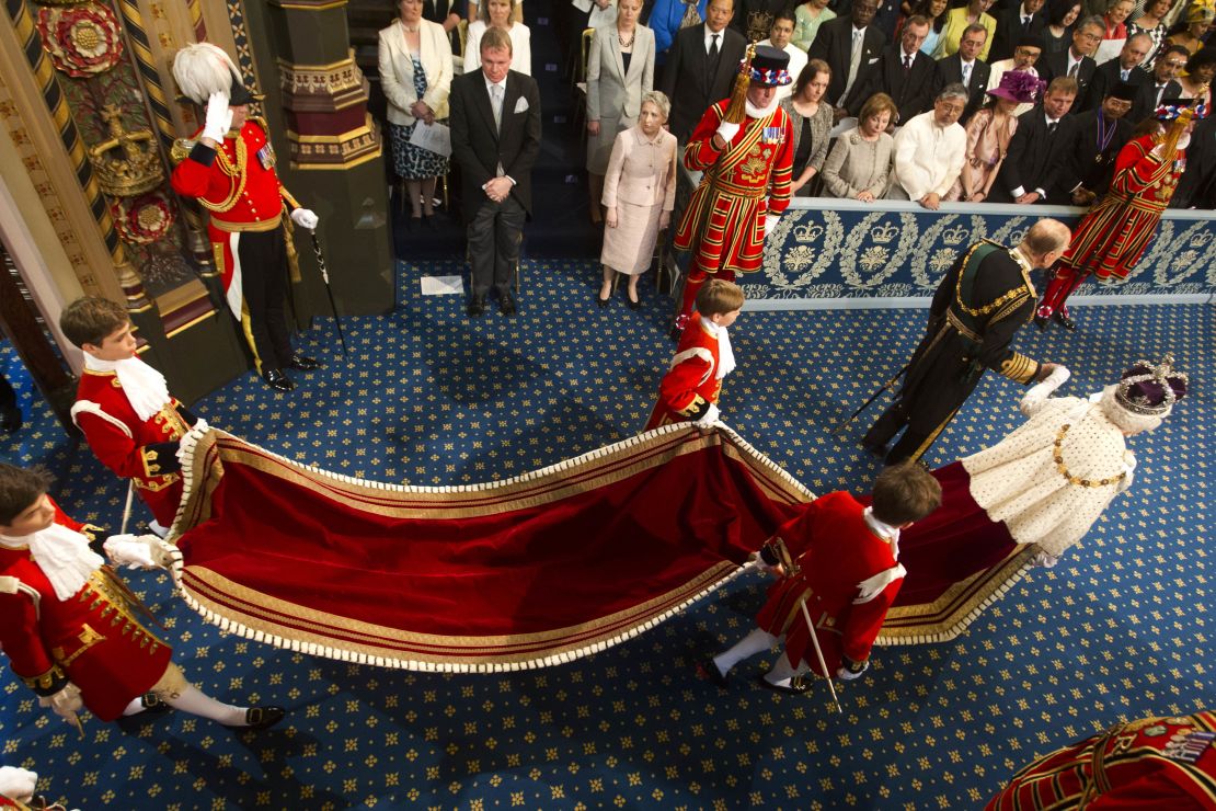 Queen Elizabeth II wearing the Robe of State, which has a five-meter train, on her arrival at the House of Lords on May 8, 2013.