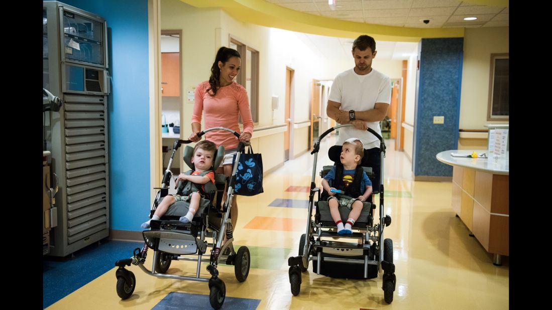 Nicole McDonald pushes a stroller with Anias as her husband Christian pushes Jadon down a hallway on June 14 at Blythedale Children's Hospital in Valhalla, New York, where the boys have been rehabilitating.