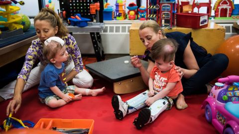 Mara Abrams, left, and Maureen Carroll work with Jadon and Anias McDonald at Blythedale Children's Hospital.