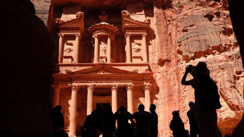 Tourists take pictures of the Khazneh (Treasury) in Jordan's ancient city of Petra on May 5, 2017. Established as the capital city of the Nabataeans, the rose rock city is Jordan's most popular touristic site and was chosen as one of the seven New Wonders of the World in 2007. / AFP PHOTO / THOMAS COEX        (Photo credit should read THOMAS COEX/AFP/Getty Images)