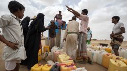 ABS IDP SETTLEMENT,  YEMEN - 6 MAY 2017. Displaced people collect potable water during the one-hour distribution window at midday. Some have lived in tents in the desert for the past two years.Water is heavily rationed and is only available during one-hour windows, which normally take place only three times a day. Giles Clarke/UN OCHA