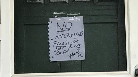 A note saying "NO interviews" was taped to the door of a juror's home.