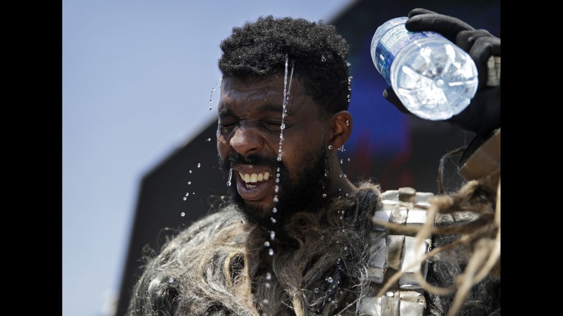 Xaviere Coleman pours water over his head in Las Vegas on Tuesday, June 20. He was wearing a Chewbacca costume to take photographs with tourists on the Strip.