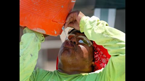 A construction worker drinks water at a job site in Phoenix on June 20.