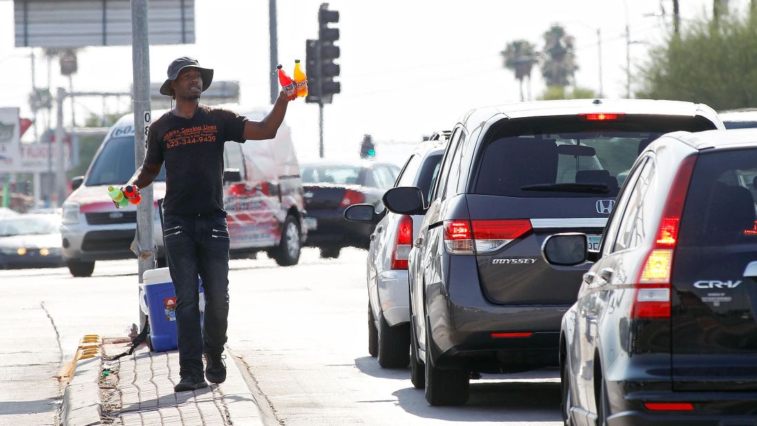 Eric Maurice Clark sells cold drinks to motorists at a busy intersection in Phoenix on June 20.