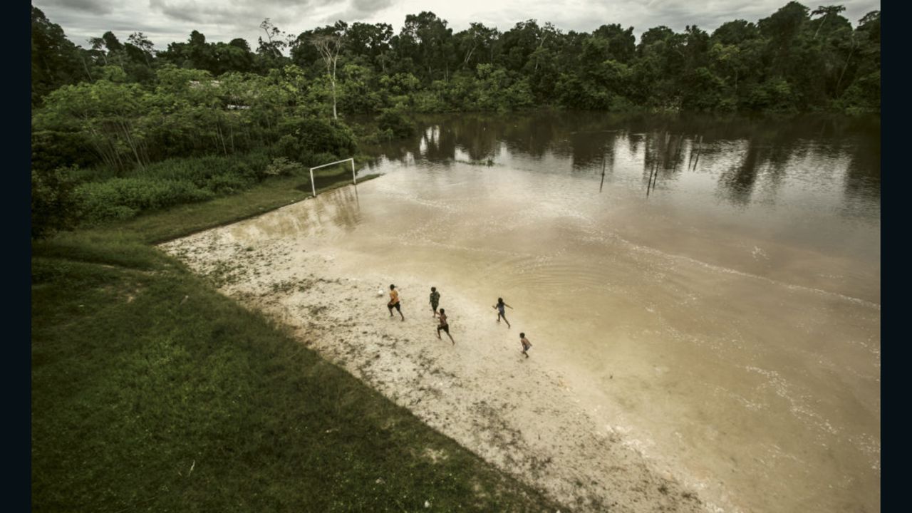This picture, taken by Ernesto Benavides, captures a group of children playing football on a flooded field near the Itaya River in the north of Peru, which is in the middle of the Amazon.