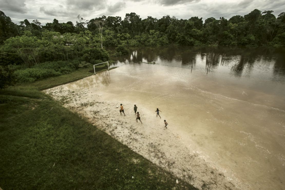 This picture, taken by Ernesto Benavides, captures a group of children playing football on a flooded field near the Itaya River in the north of Peru, which is in the middle of the Amazon.