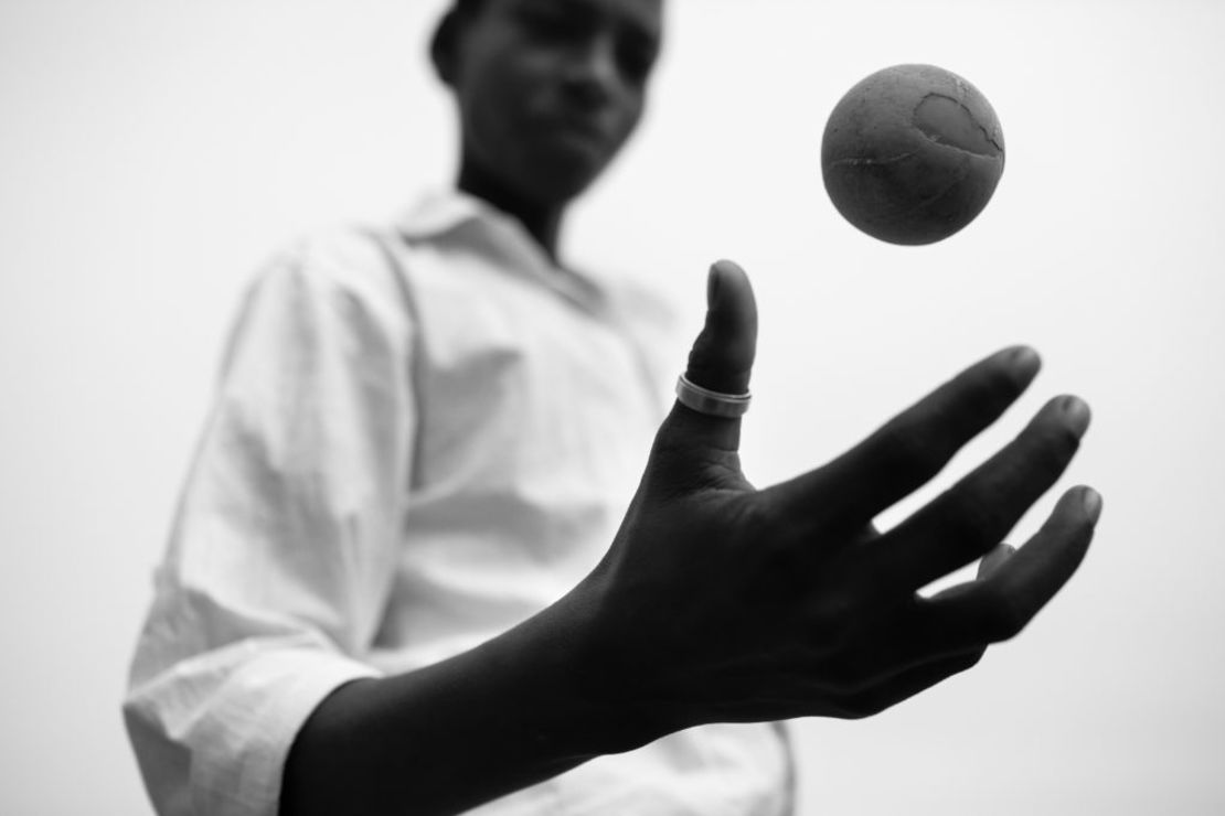 This photo is part of a project created by David Jimenez titled "Omen." Here a young boy in India plays with a worn cricket ball. 