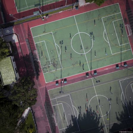 Footballers play in Shatin sports ground in Hong Kong's New Territories. 
