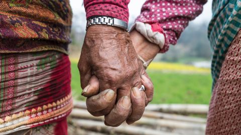 Widows hold hands in Chapaguan, Nepal