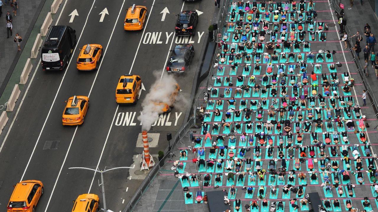 People do yoga in New York's Times Square as part of an annual event celebrating the summer solstice, the longest day of the year, on Wednesday, June 21. It was also International Yoga Day.