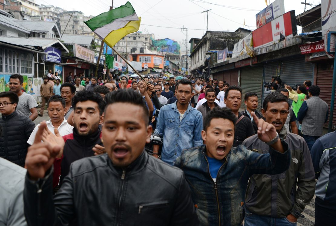 Indian supporters of the separatist Gorkha Janmukti Morcha (GJM) group shout slogans while demonstrating during an indefinite strike called in Darjeeling on June 19, 2017.
