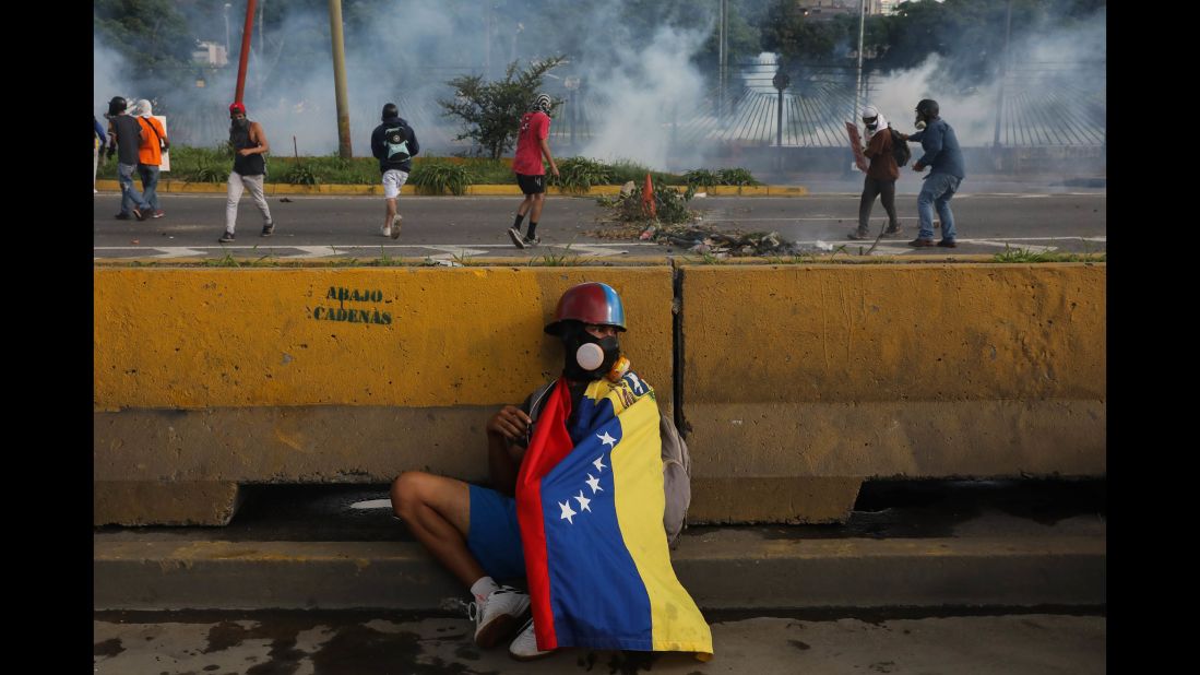 A protester hides behind a barrier in Caracas on June 22.