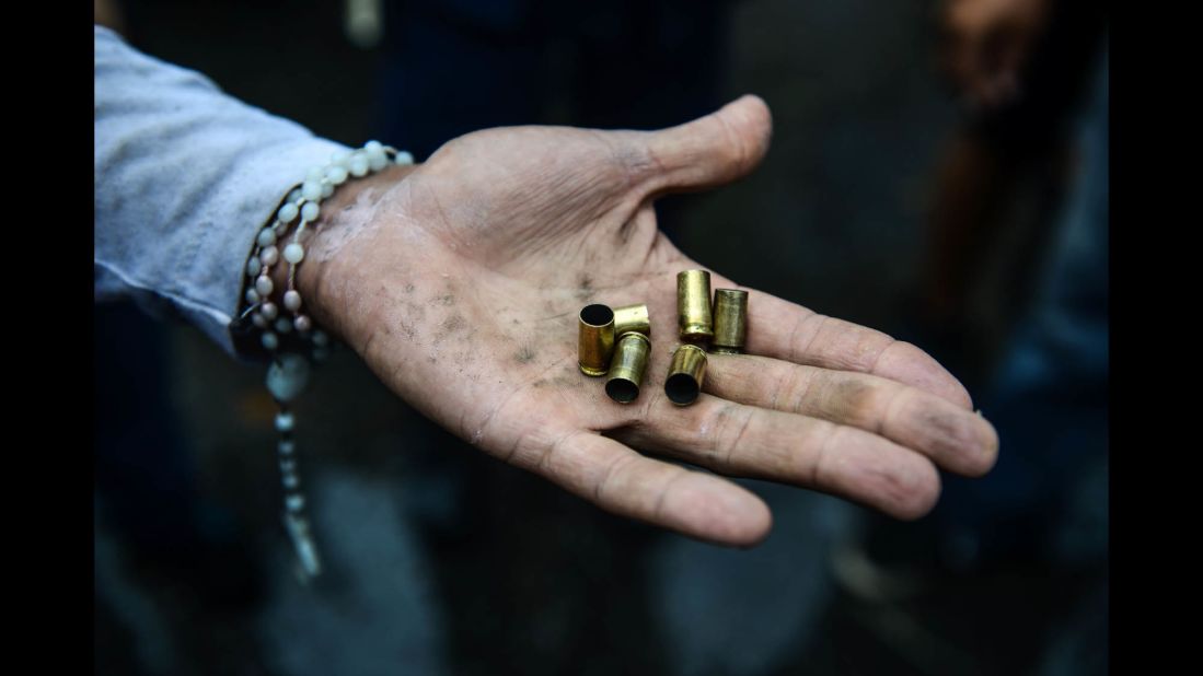 An opposition activist displays bullet shells during an anti-government demonstration on Monday, June 19.