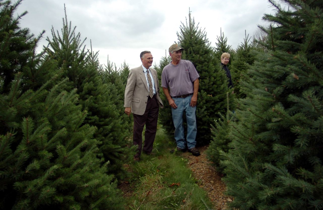 Gary Walters, chief usher of the White House, (left) talks with tree farm owner Francis Botek about picking out a Christmas tree for the Blue Room of the White House at Crystal Spring Tree Farm in Mahoning Township, Pennsylvania October 18, 2006. On the right is Margaret Botek. 